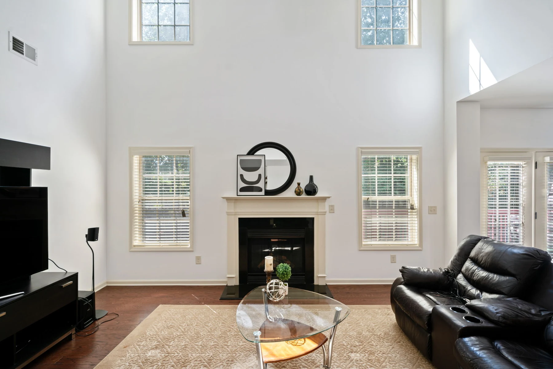 Two-story family room with tall windows and fireplace